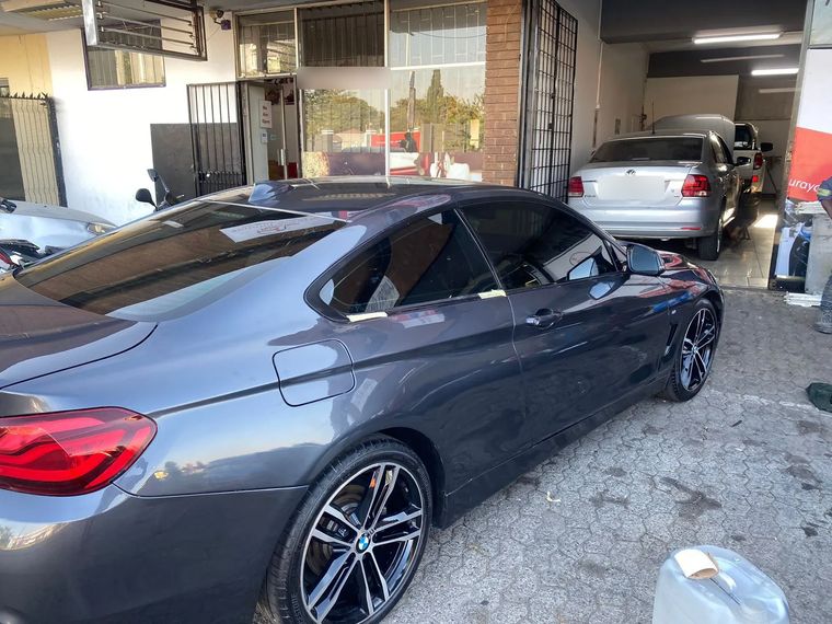 Grey BMW 4 Series coupe after repair and respray, parked outside the Panel Tech workshop